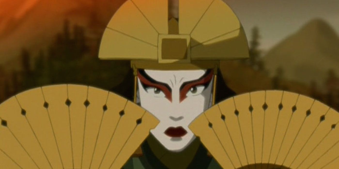 Kyoshi holding her fans next to her face in Avatar The Last Airbender.