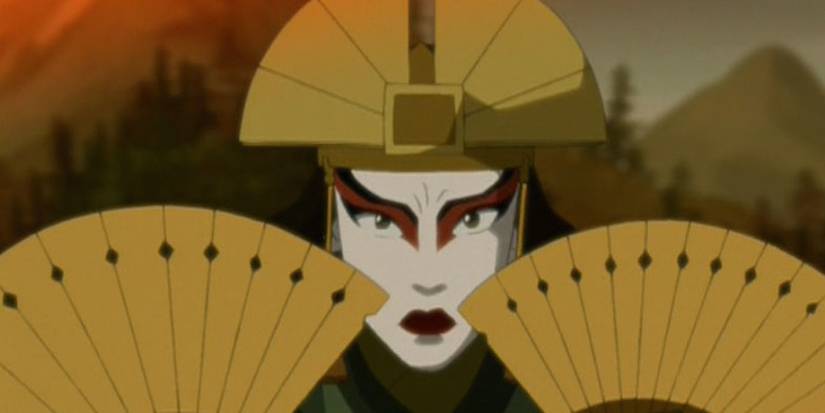 Kyoshi holding her fans next to her face in Avatar The Last Airbender.