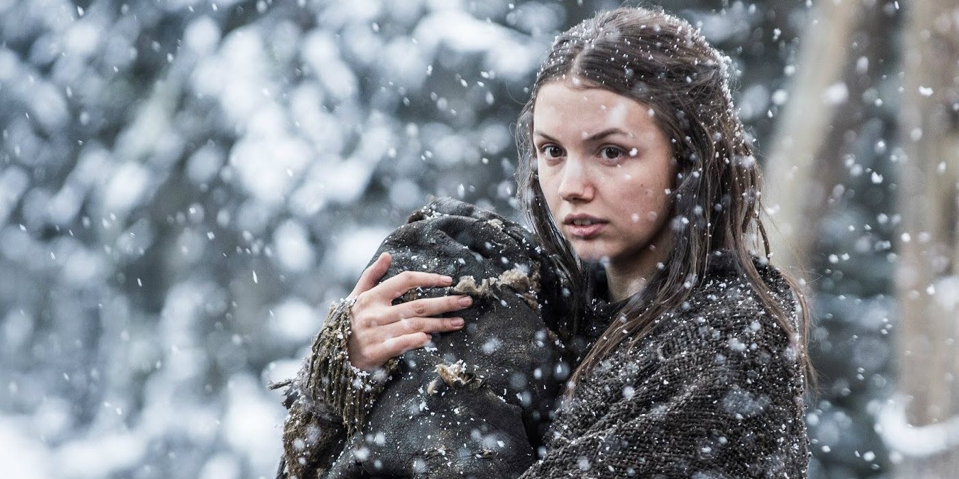 Gilly holding baby Sam under the snow in Game of Thrones.