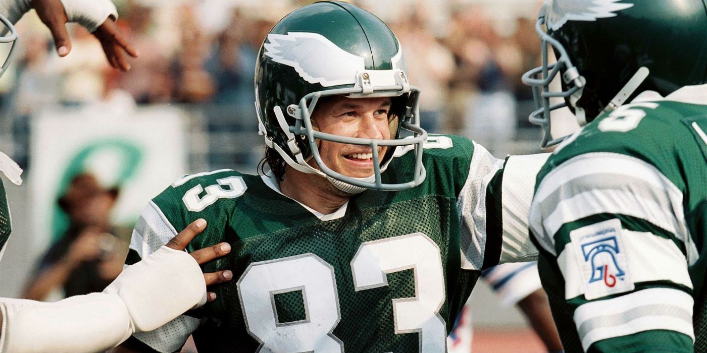 Mark Wahlberg smiling on the football field in Invincible