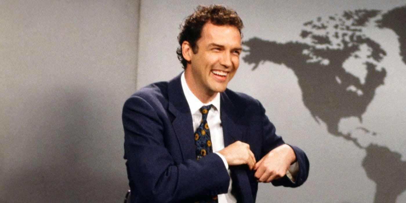 Norm Macdonald laughs while putting his note away on Weekend Update.