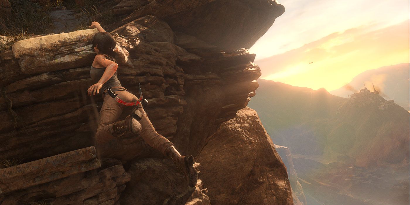 Lara Croft hangs on a cliff's edge as the sun rises in Rise of the Tomb Raider