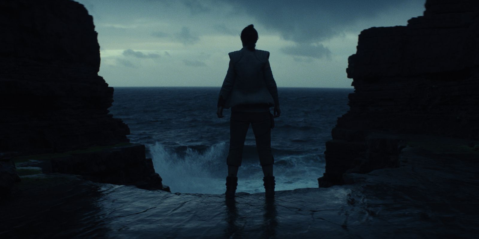 Rey standing in a cave in The Last Jedi