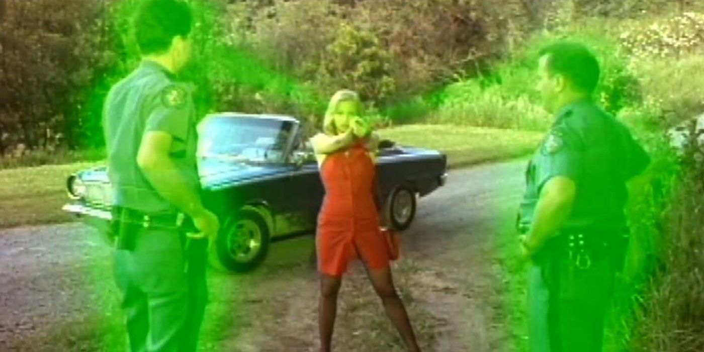 Glowing police officers and red dressed woman holding a gun in Tommyknockers miniseries