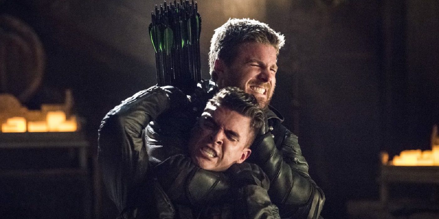 Oliver holds Adrian in a headlock in Arrow