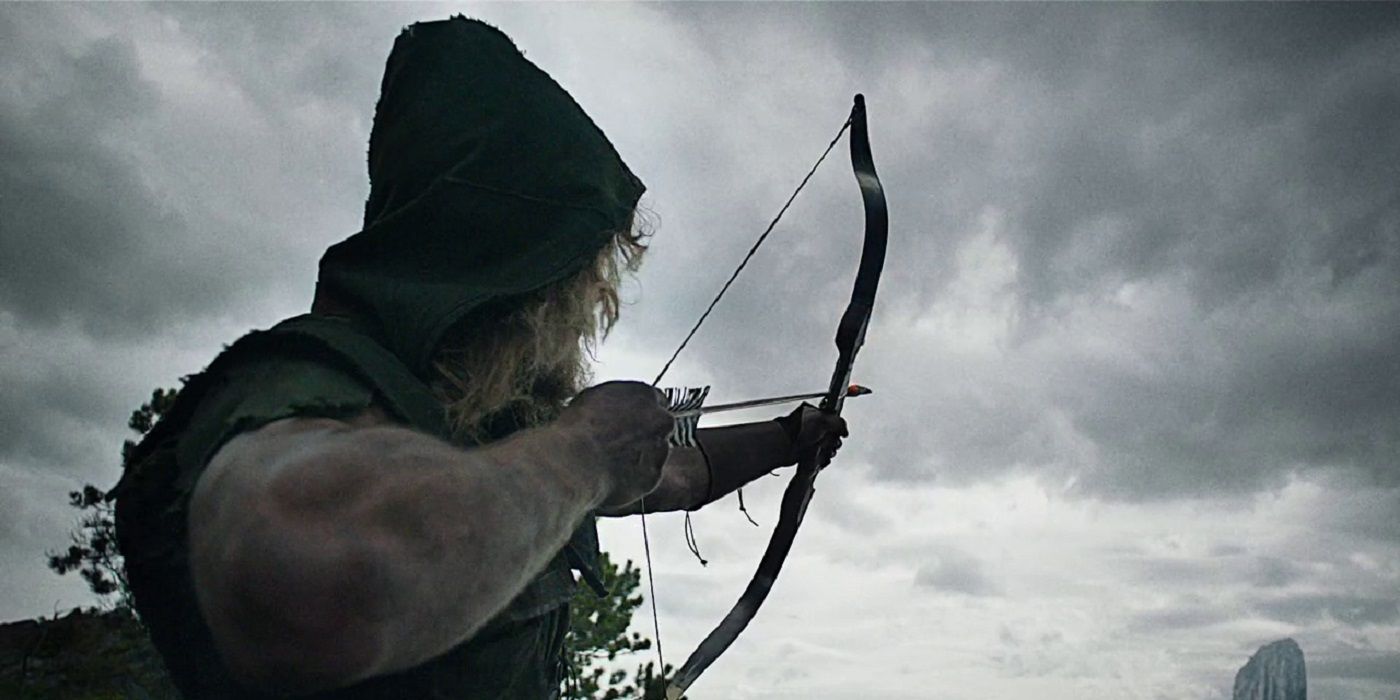 Oliver Queen pointing a bow and arrow during the Pilot episode of Arrow