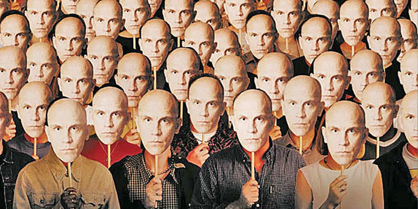 A sea of people with John Malkovich's face look on from the Being John Malkovich poster