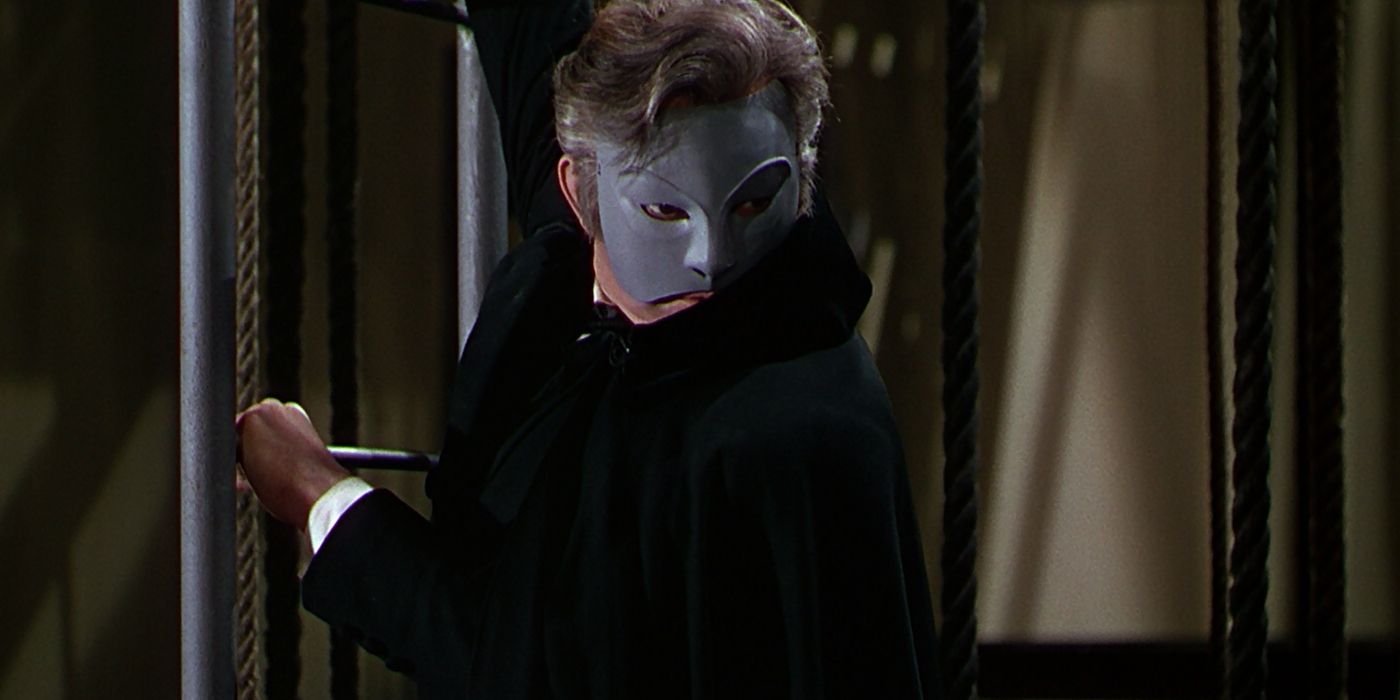 The Phantom looks on from The Phantom of the Opera 