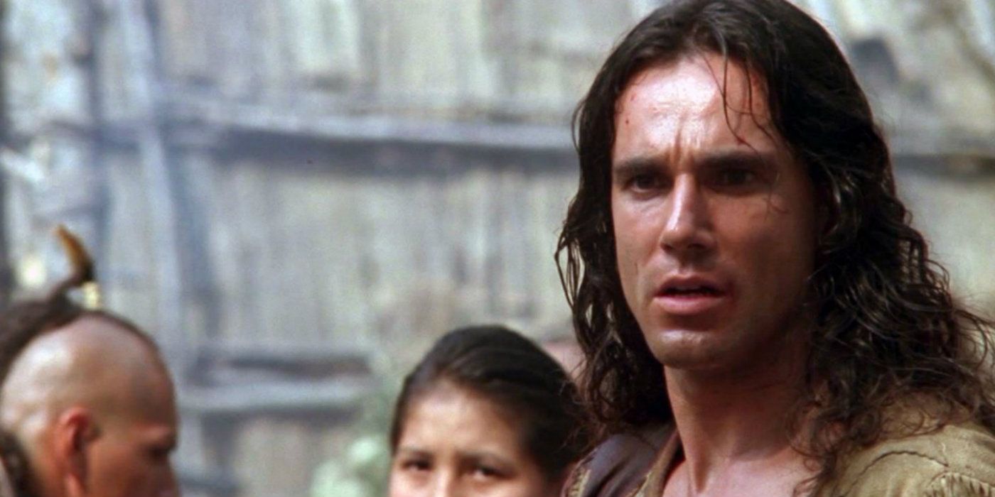 Daniel Day-Lewis staring ahead with an angry expression in The Last of the Mohicans