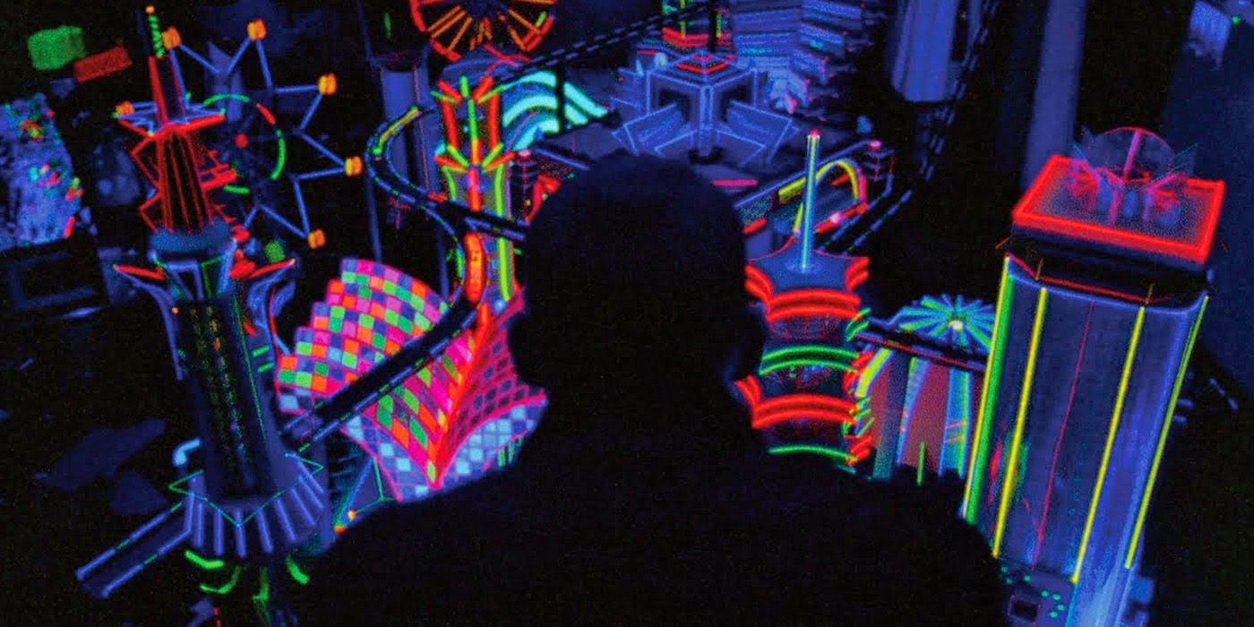 Oscar looks at a miniature city in Enter the Void