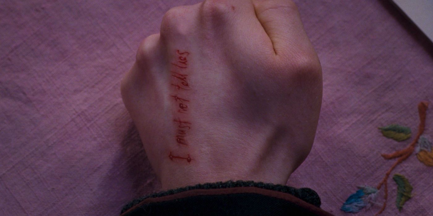The words I Must Not Tell Lies on Harry Potter's hand
