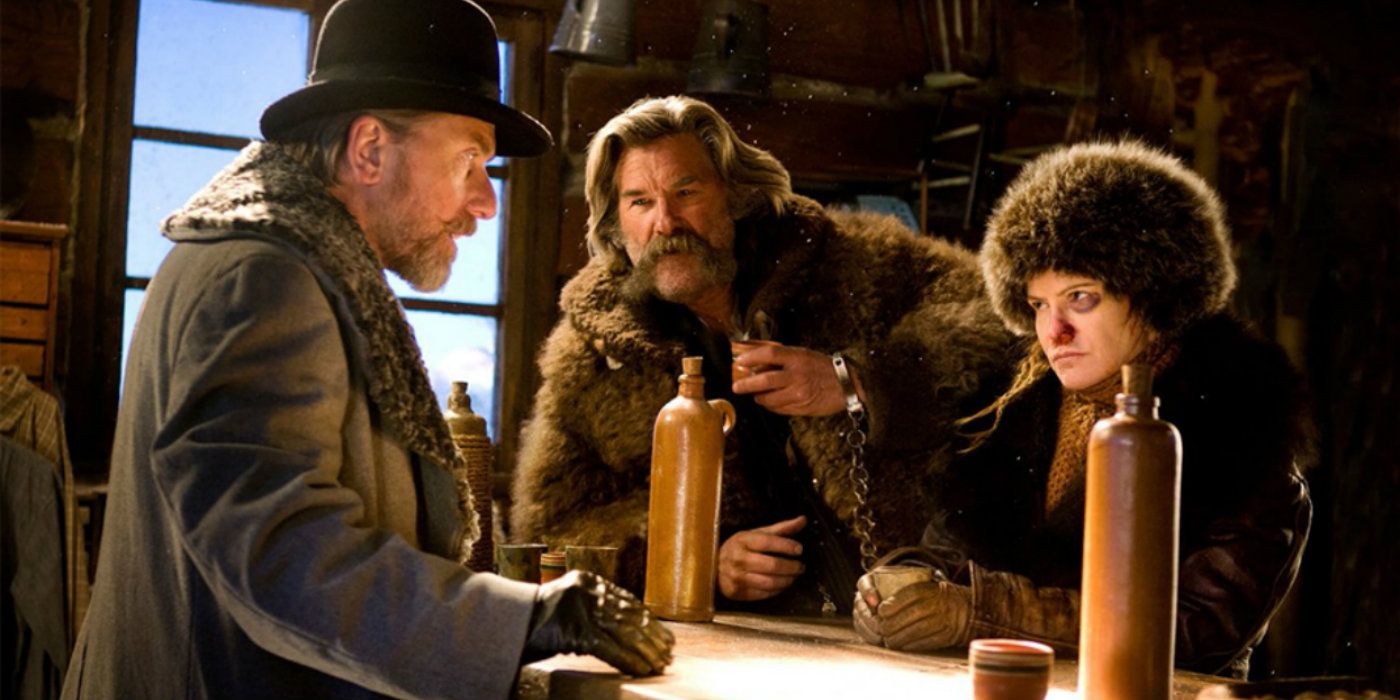 Oswaldo, John, and Daisy talk around a table in The Hateful Eight