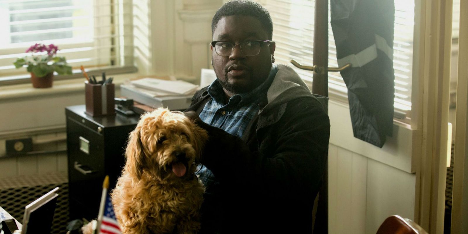 Rod holding a dog in Get Out