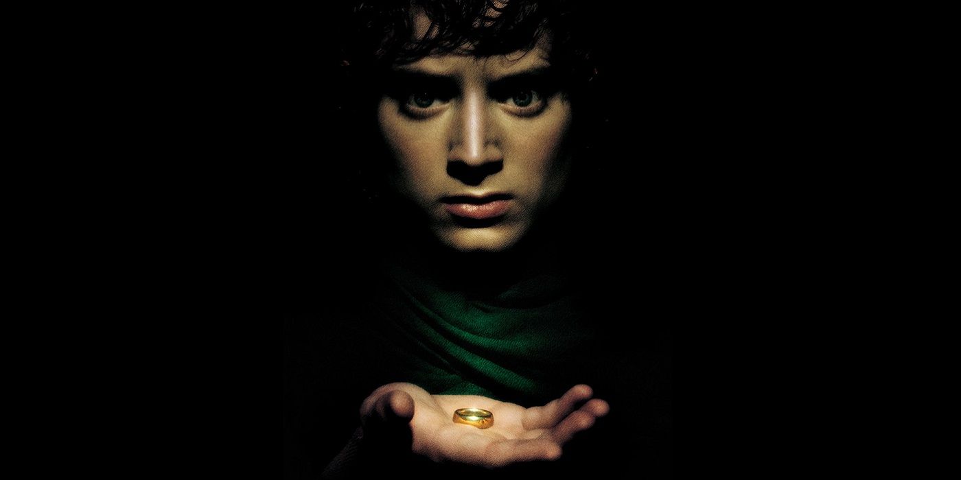 Frodo holding the One Ring surrounded by darkness in lord of the Rings. 