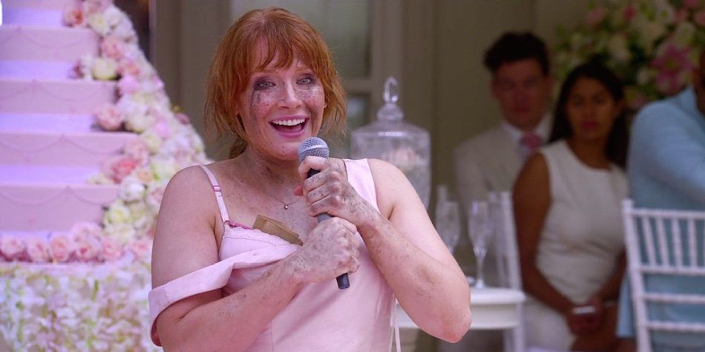 Bryce Dallas Howard as Lacie in Black Mirror episode Nosedive, holding a mic and smiling.