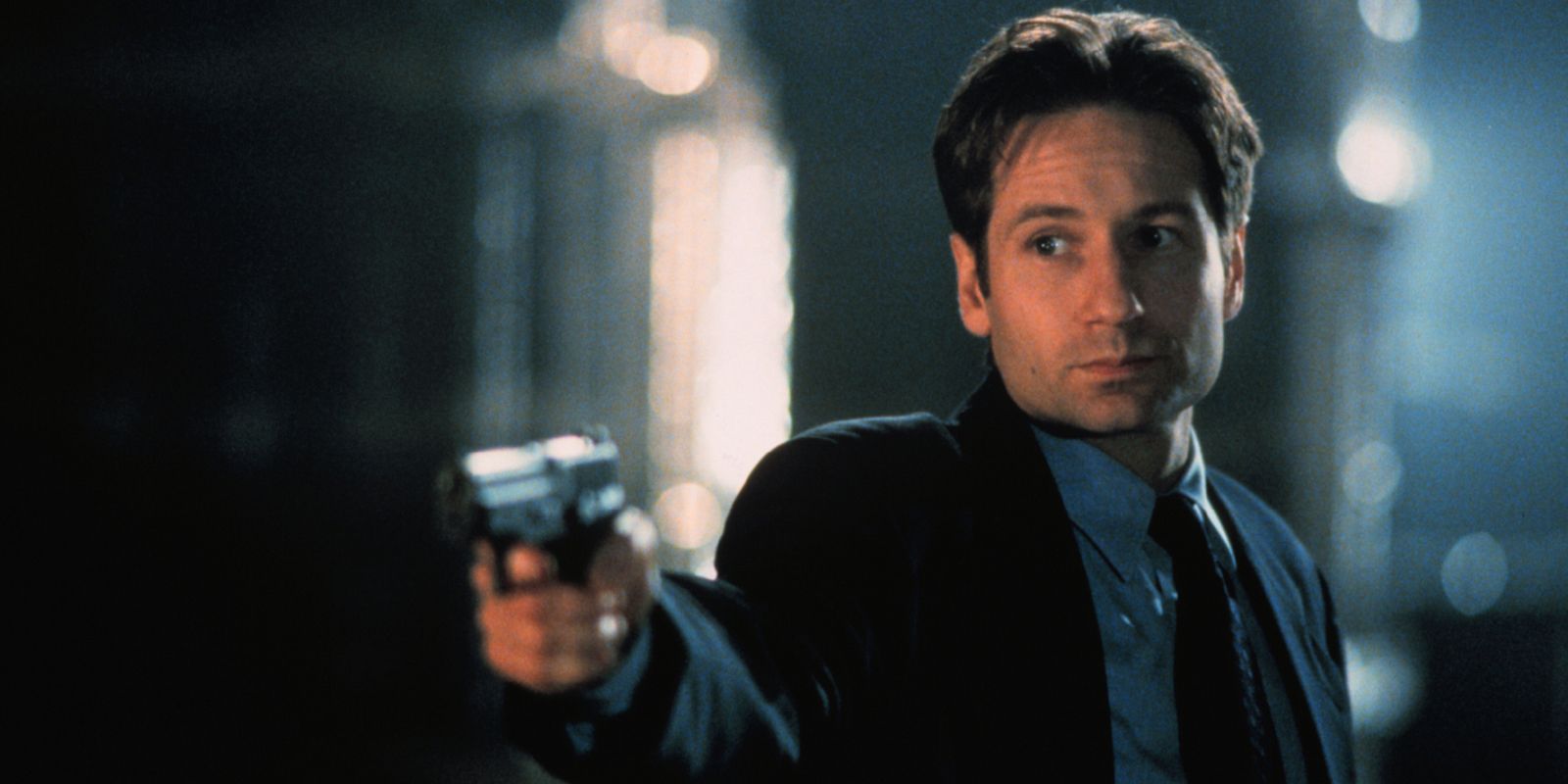 Fox Mulder pointing a gun in the X Files series.