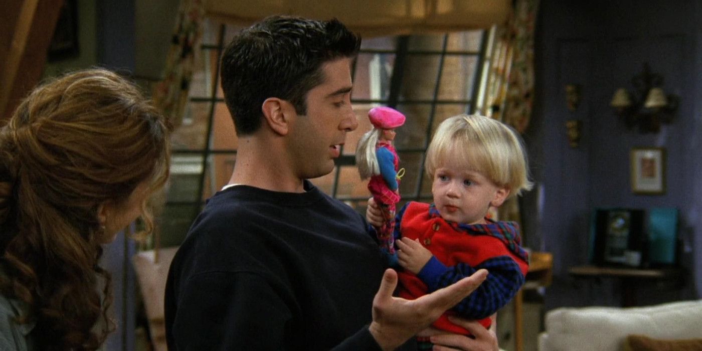 Ross holding Ben who has a Barbie