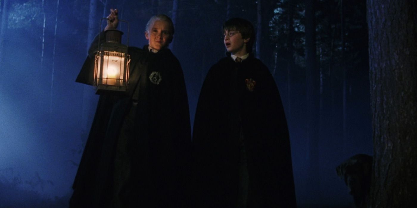 Draco holds a lantern and walks with Harry in the Forbidden Forest in Harry Potter and the Sorcerer's Stone