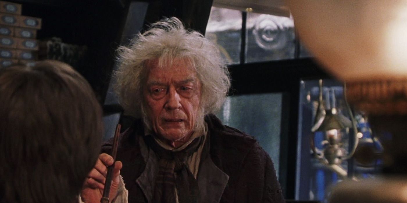 Ollivander holding a wand in Harry Potter.