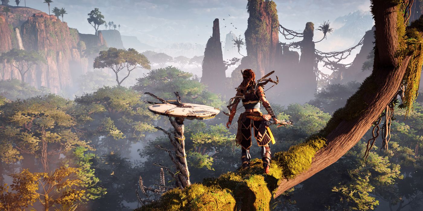 A photo of Aloy on top of a tree looking at a Tallneck in Horizon Zero Dawn.