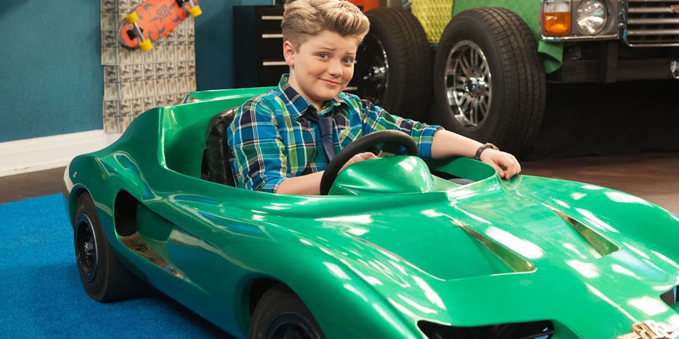 RIchie sits in a green toy sports car in Richie Rich