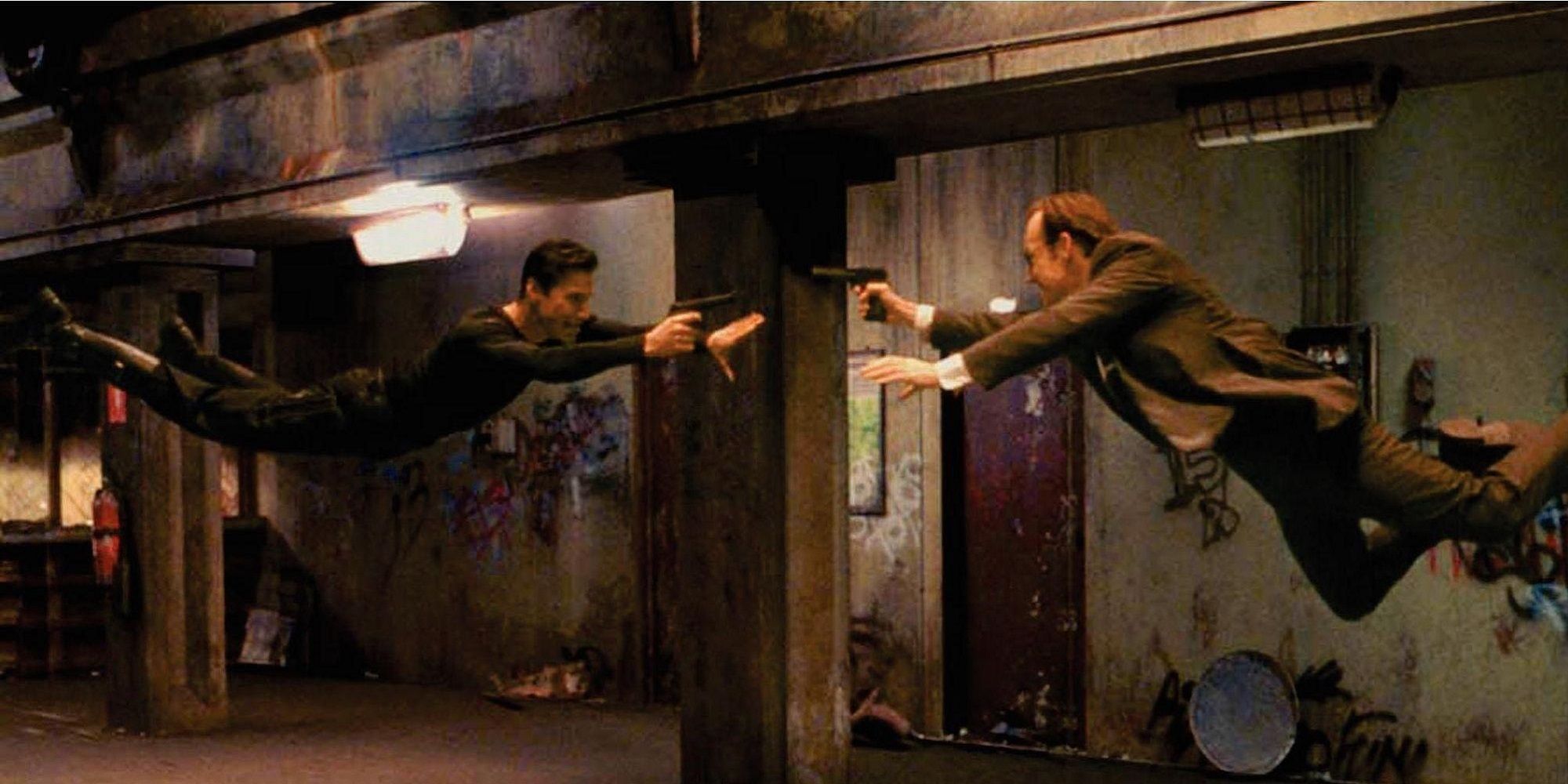 Neo and Agent Smith jumping at each other firing guns in The Matrix