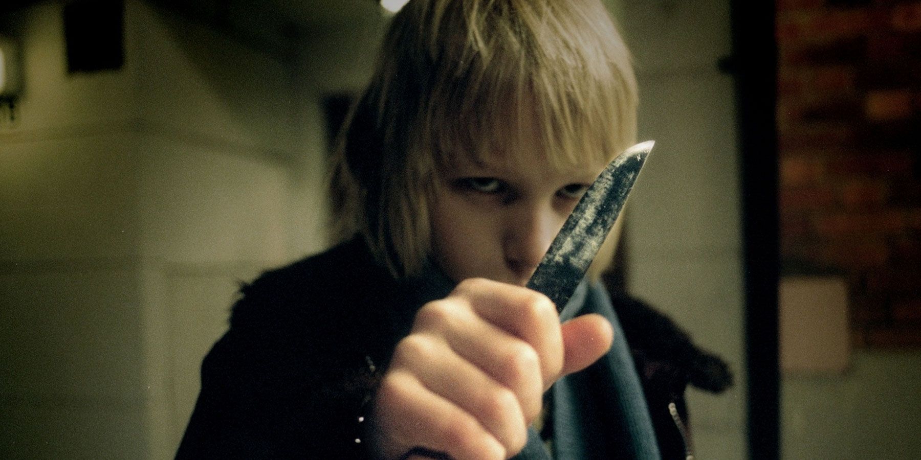 Oskar holding a knife in Let The Right One In