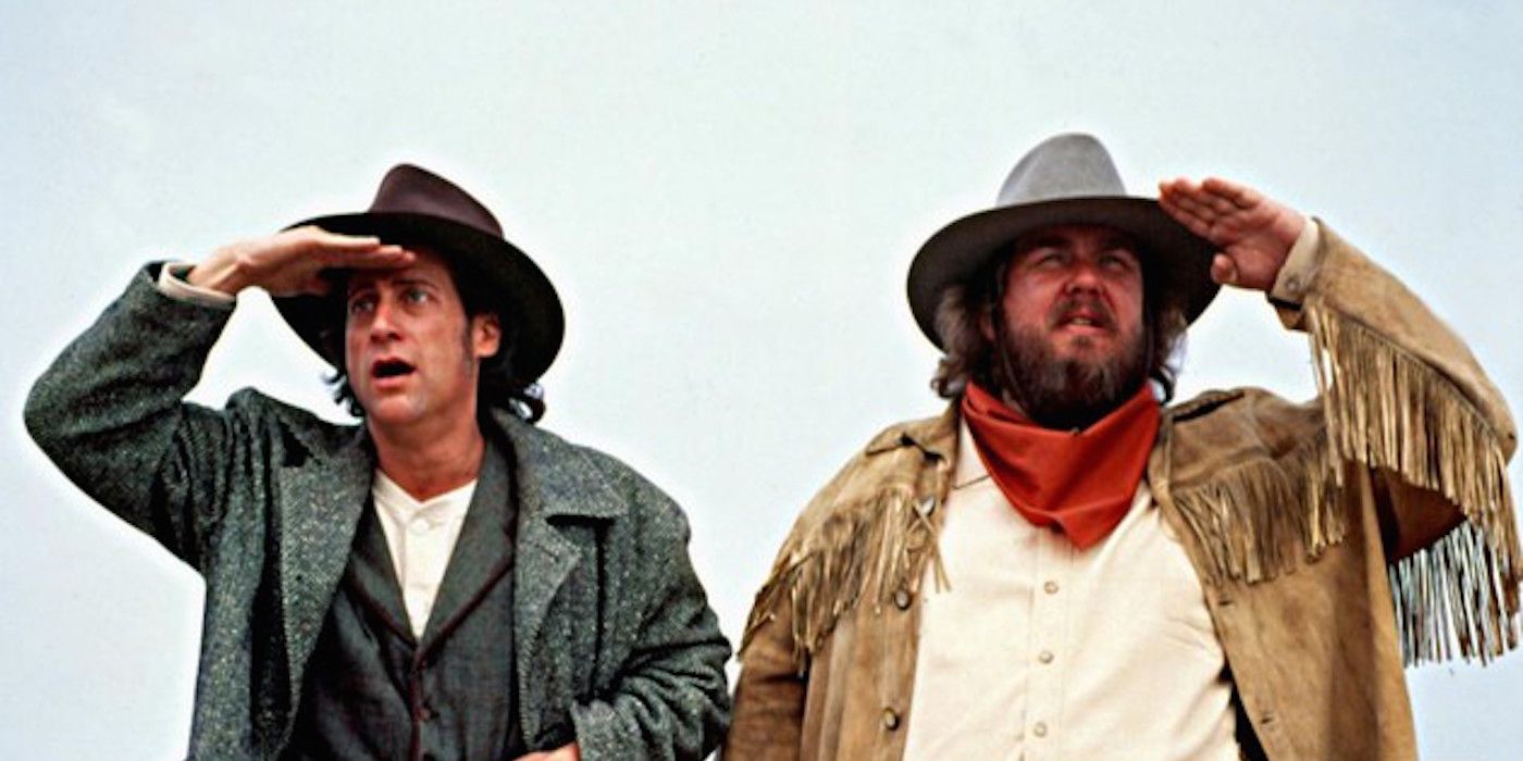 John Candy and Richard Lewis look out on their horses in Wagons East