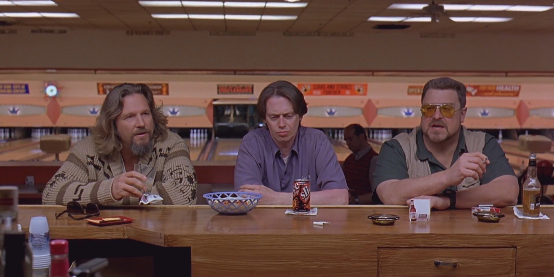 Dude, Walter, and Donny sit at the bar in the bowling alley in The Big Lebowski