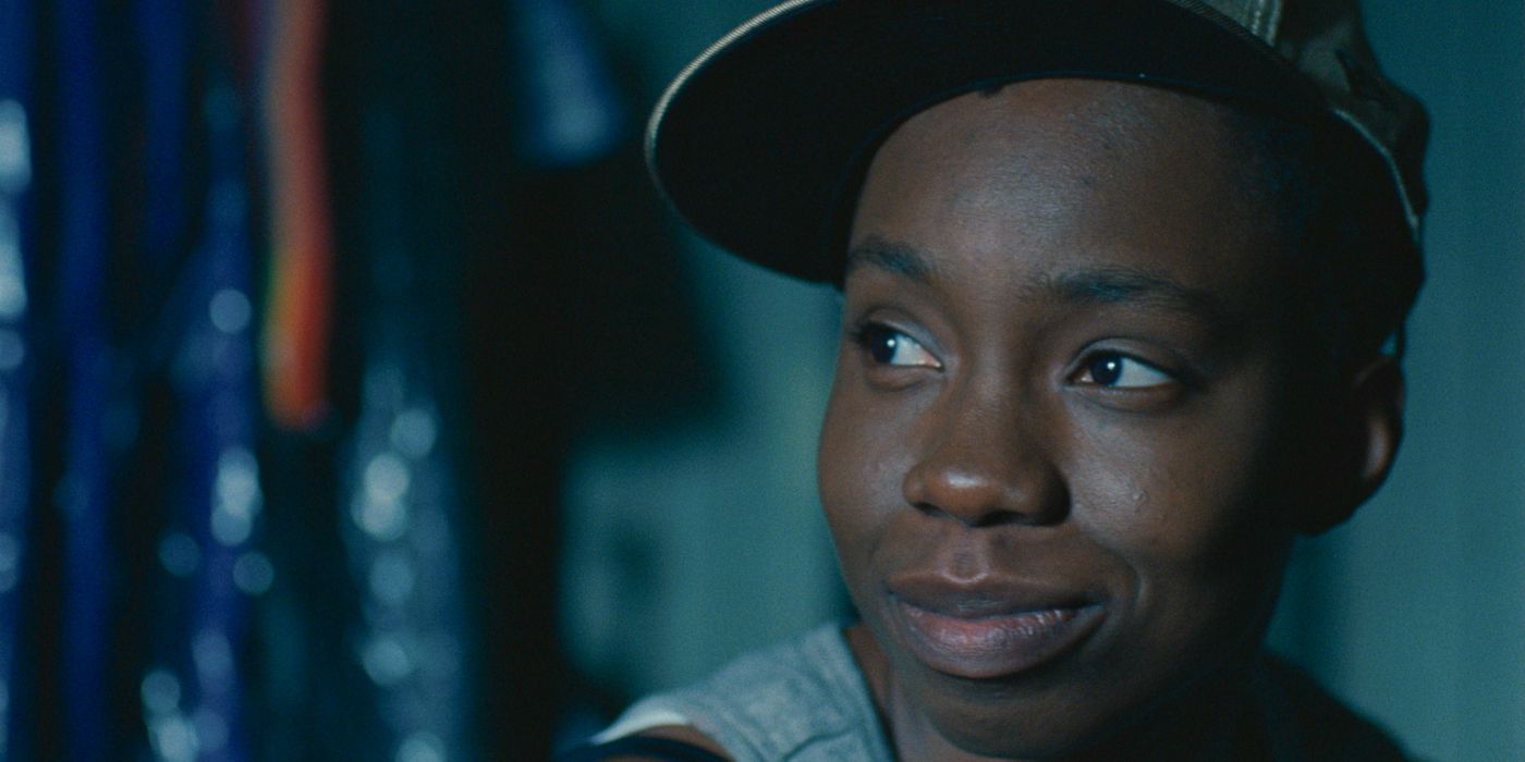 Pariah smiling at something off-camera in the film of the same name.