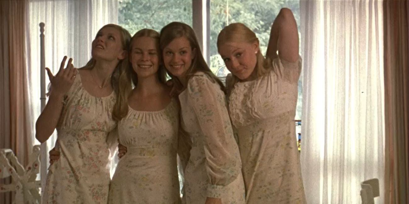 The sisters pose together in white dresses in The Virgin Suicides