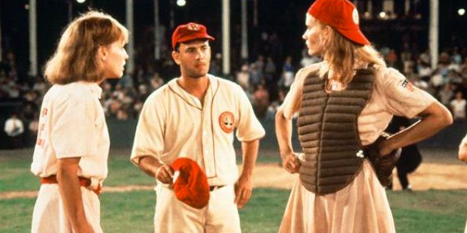 Dottie, Kit, and Jimmy on the mound during a game in A League of Their Own