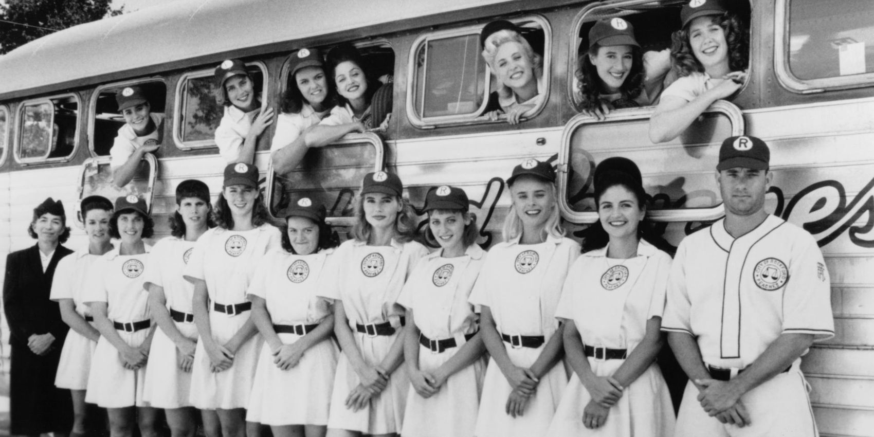 The Rockford Peaches posing in front of a bus in A League Of Their Own.