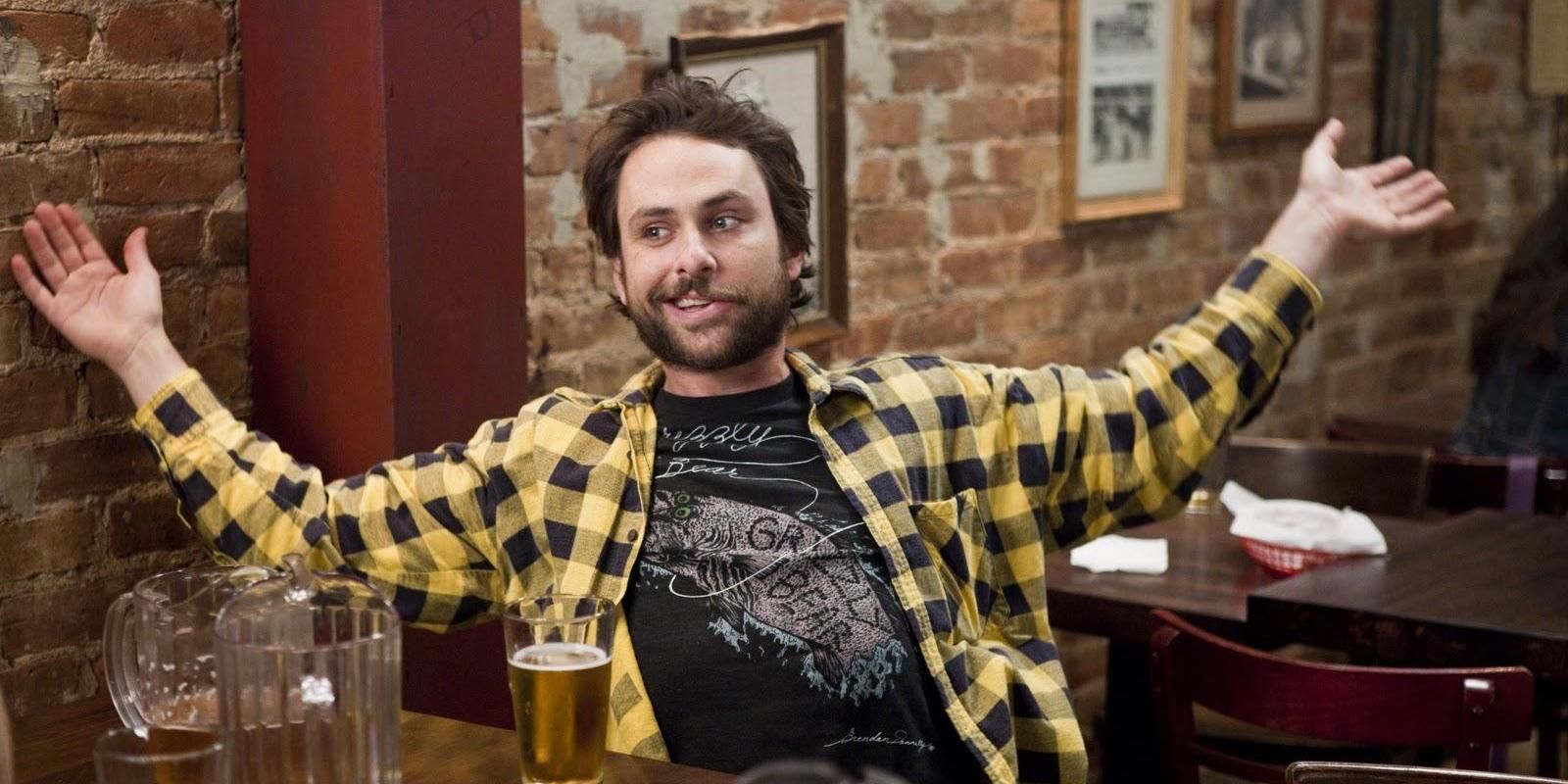 Charlie Kelly with his arms out in It's Always Sunny