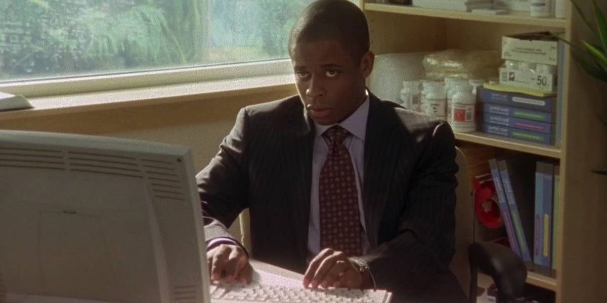 Burton Guster sits at his desk in his pharmaceutical sales office in the pilot episode of Psych