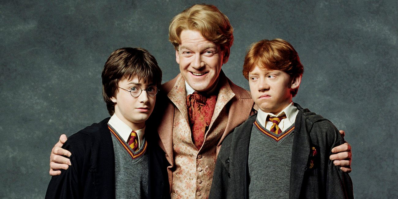 A smiling Gilderoy Lockhart posing with a frowning Harry Potter and Ron Weasley