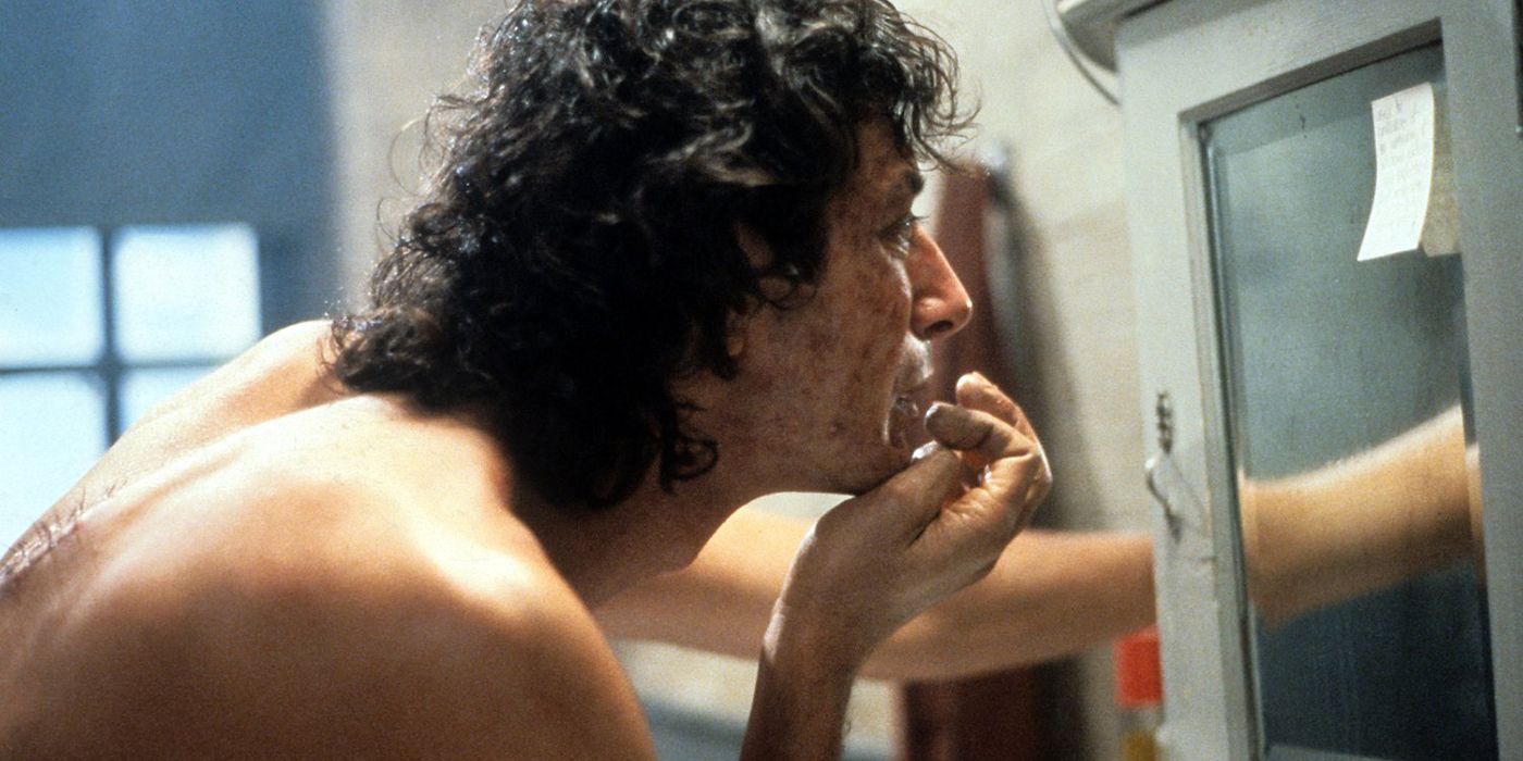 Jeff Goldblum looking in a mirror in The Fly