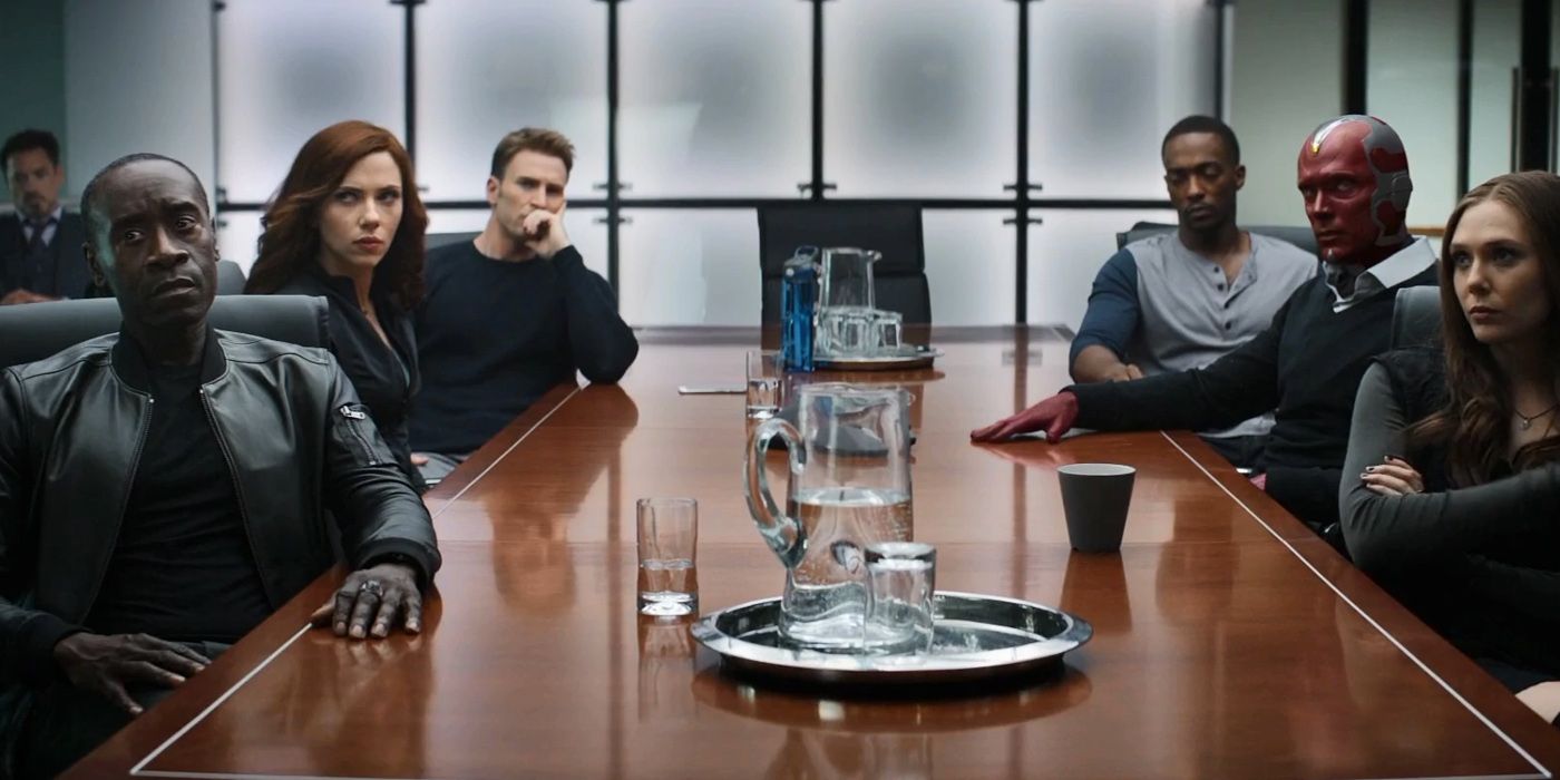 The Avengers sit together by a conference table