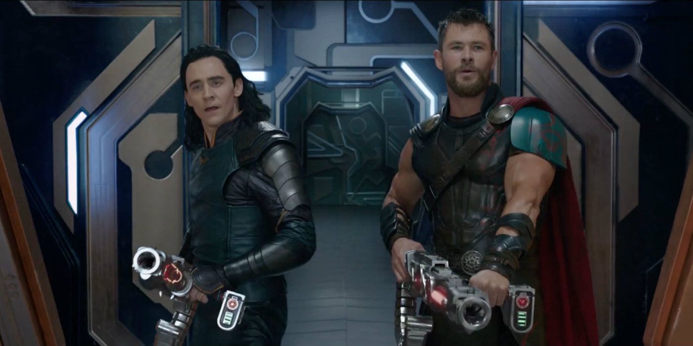 Loki and Thor pointing guns in the same direction in Thor: Ragnarok.