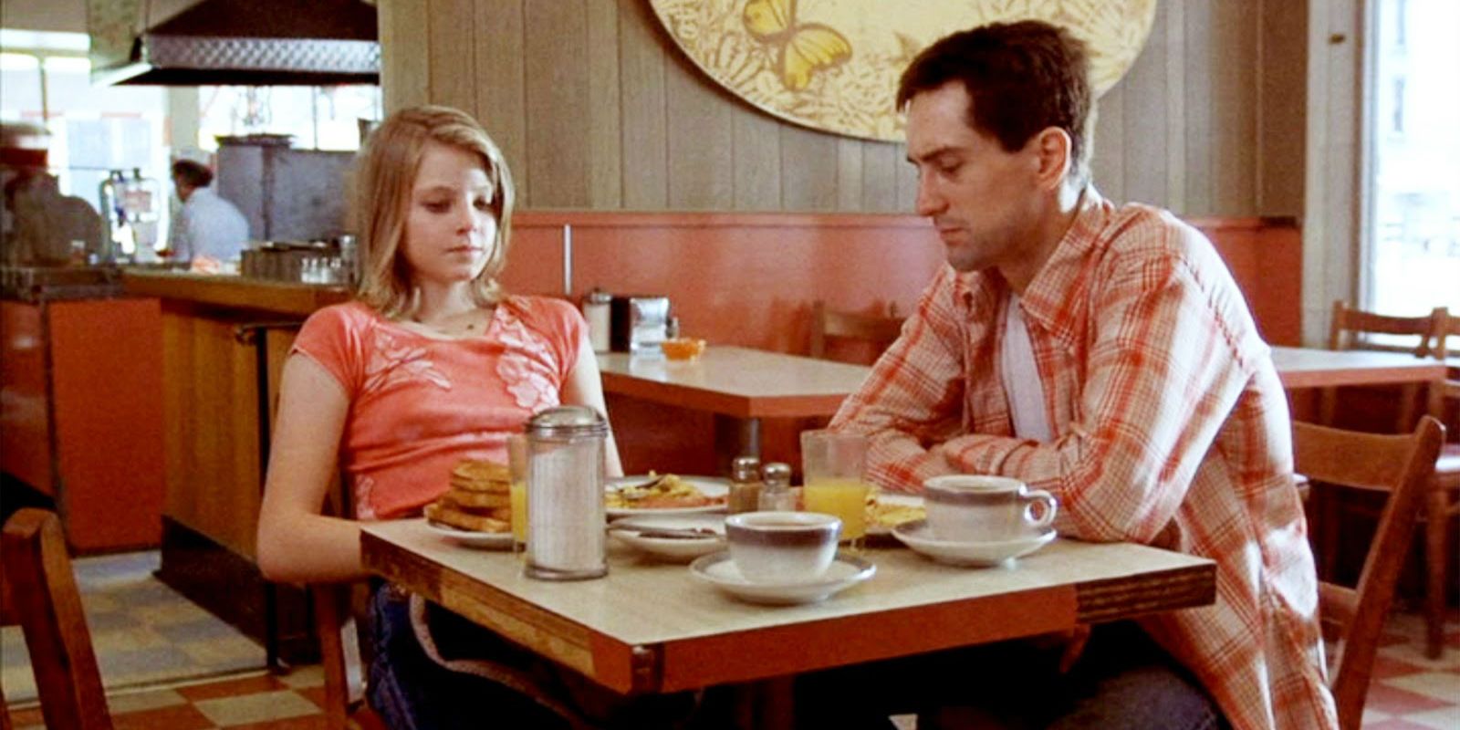 Jodie Foster and Robert DeNiro sitting in a diner in Taxi Driver