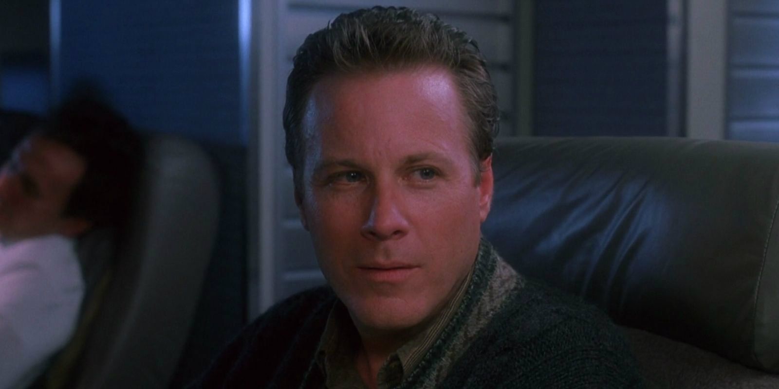 John Heard sentado em um assento em Home Alone