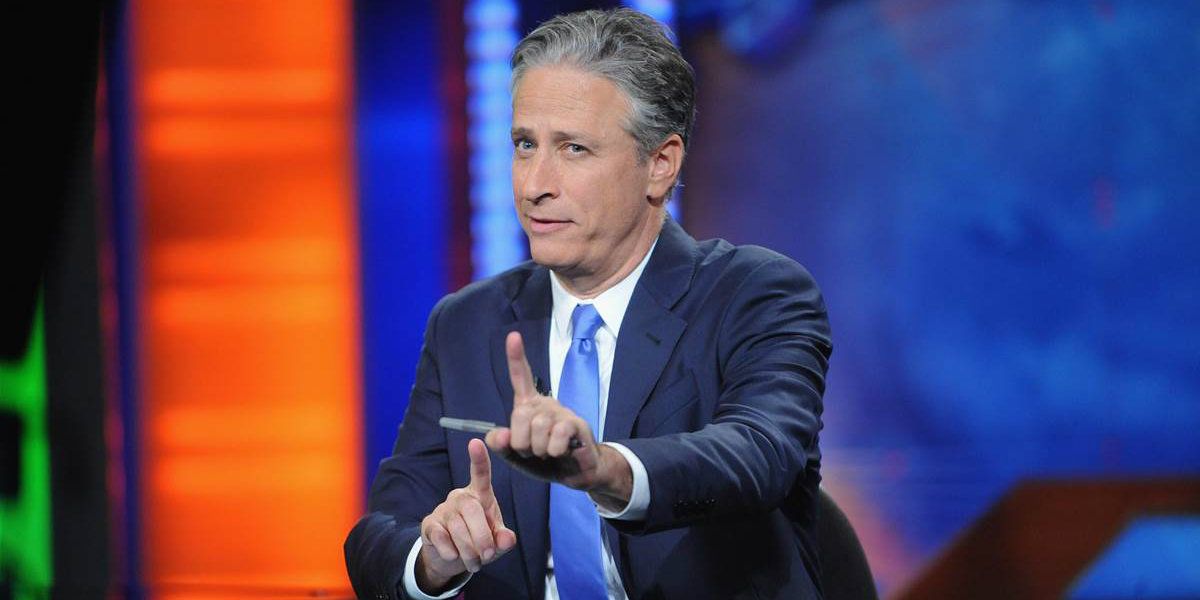Jon Stewart on The Daily Show pointing bot of his index fingers up