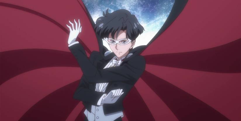 Tuxedo Mask appears with his hand raised for an attack.