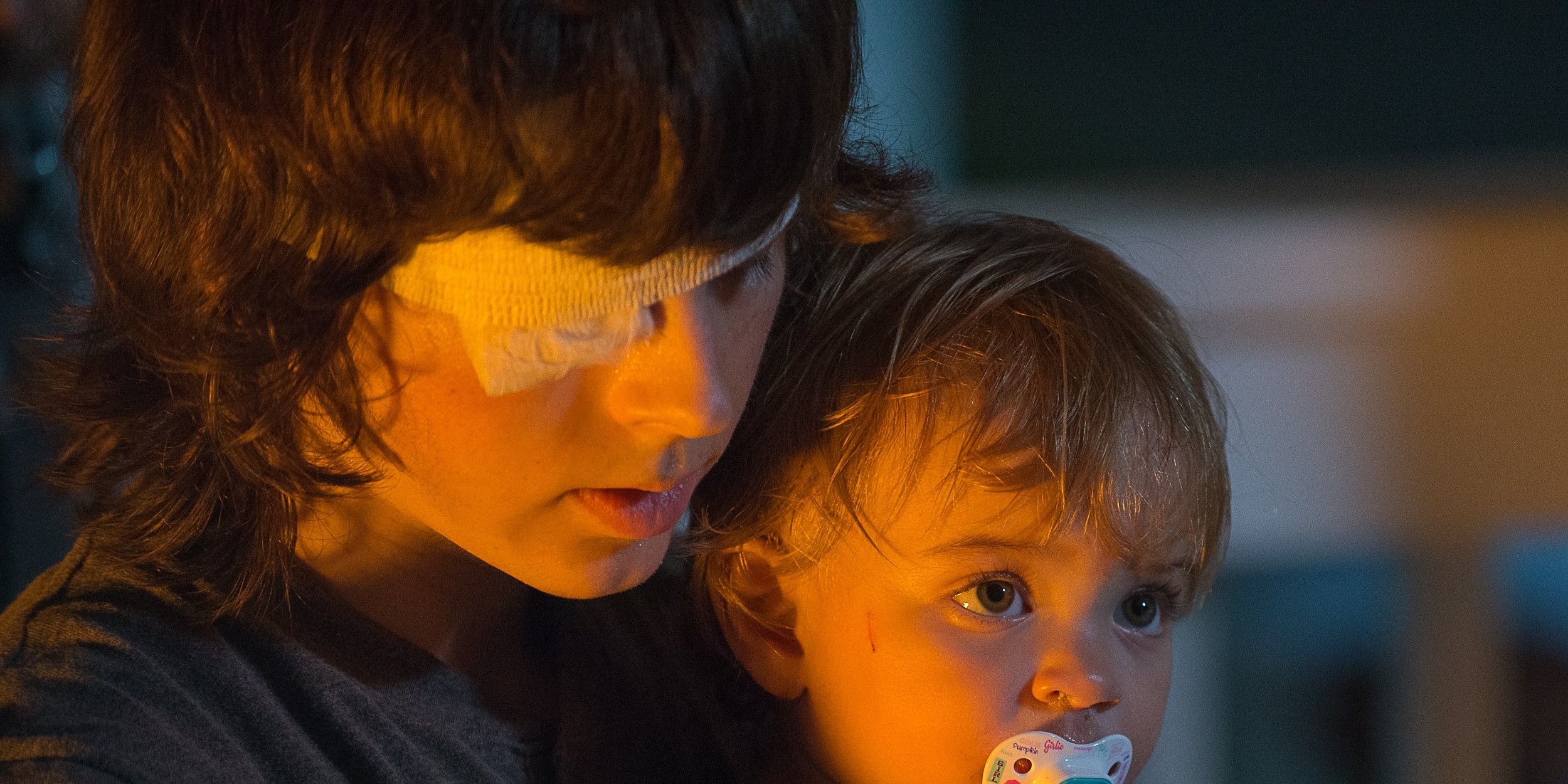 Chandler Riggs as Carl Grimes and a baby as Judith in The Walking Dead
