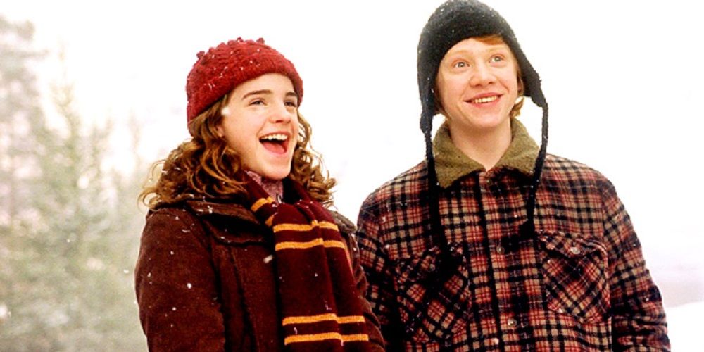 Hermione and Ron Laughing in the Snow in Harry Potter.