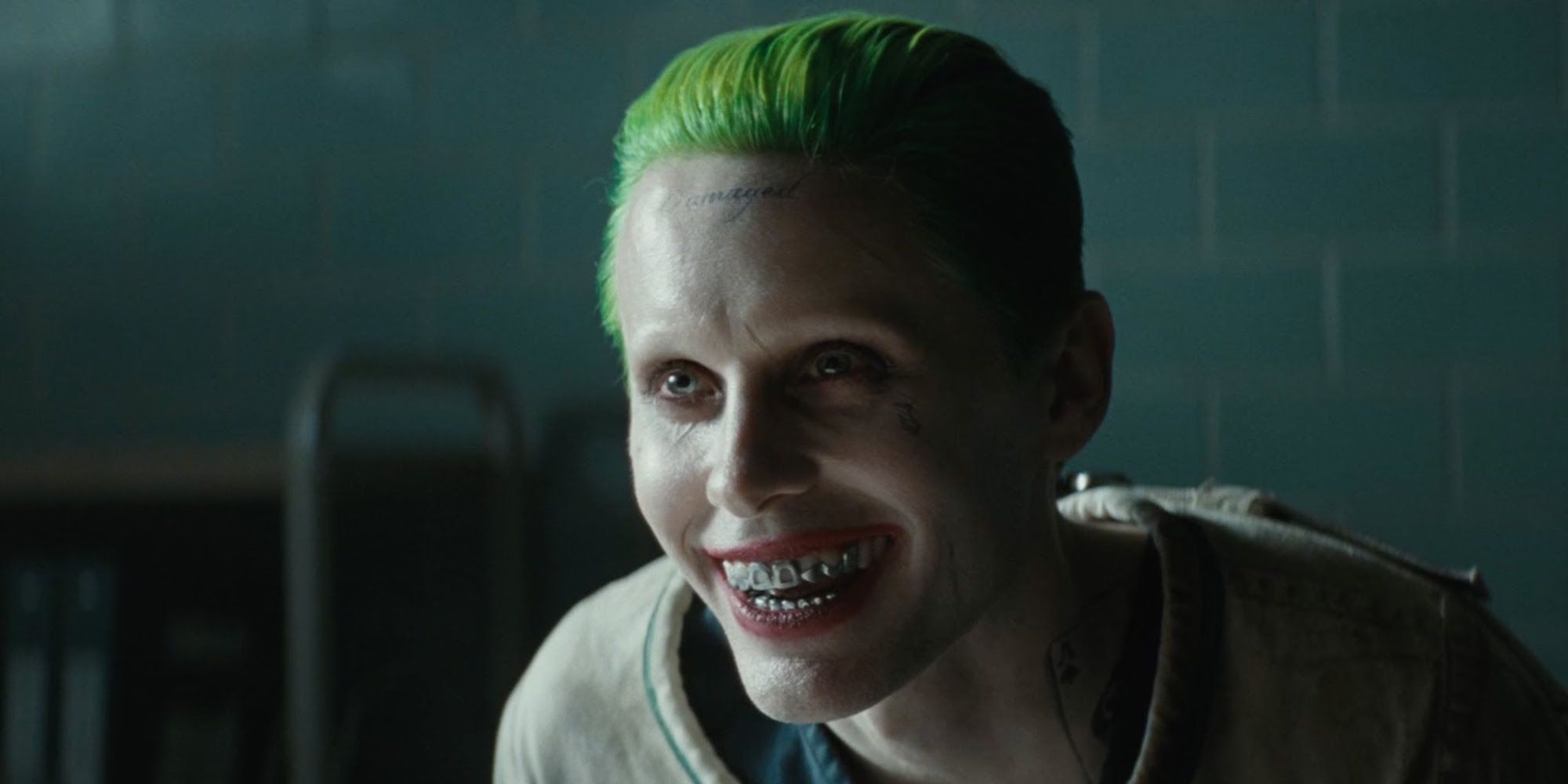 Jared Leto as the Joker in Suicide Squad smiling maniacally as he looks ahead