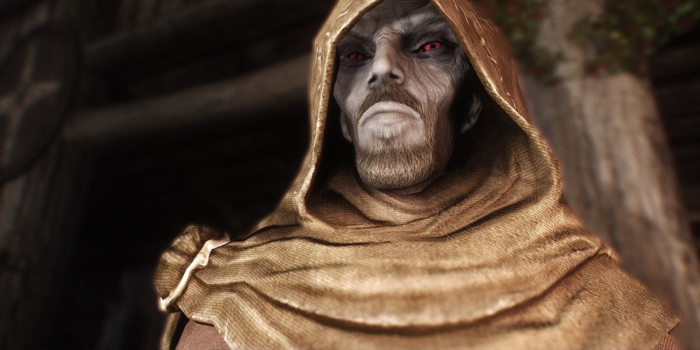 A portrait of Erandur in his mage cloak in Skyrim, looking down at the camera with an angry expression.