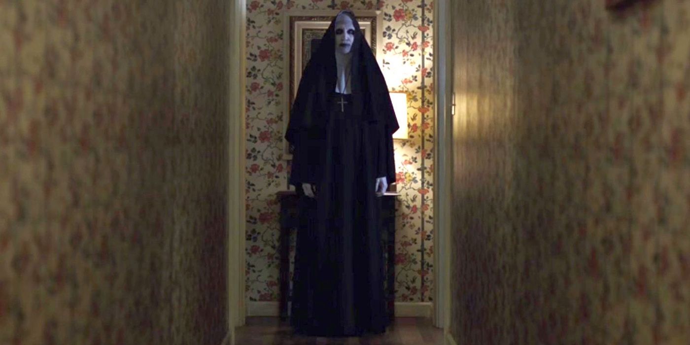 The Nun stands in a hall in The Conjuring 2