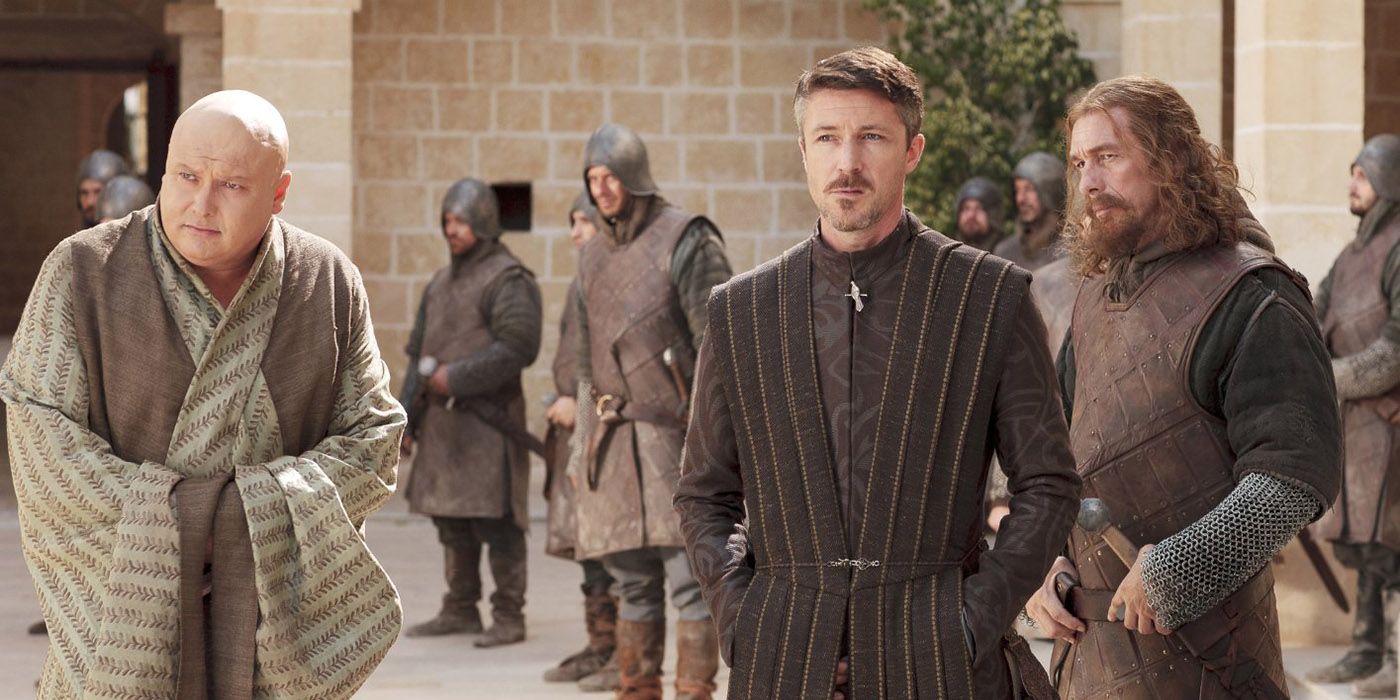 Varys, Ned, and Littlefinger in the streets of King's Landing surrounded by soldiers in Game of Thrones