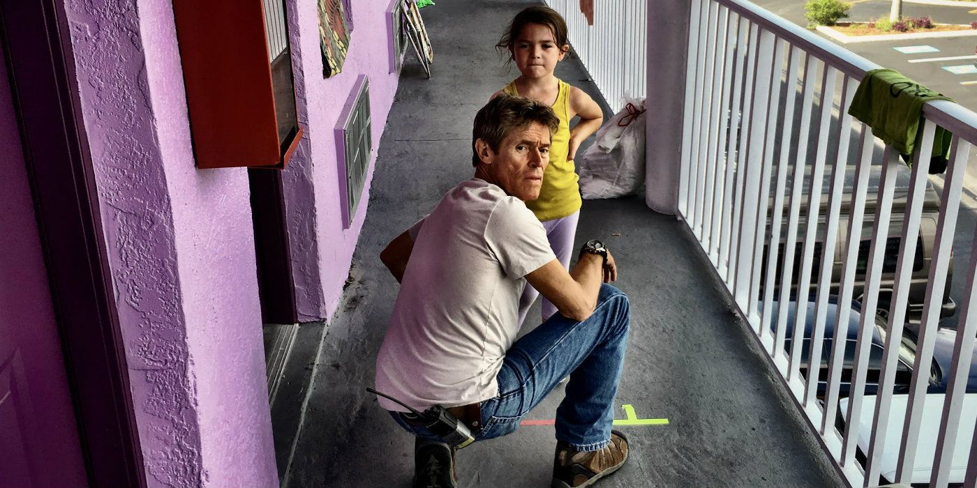 Willem Dafoe kneeling and talking to a young girl in The Florida Project
